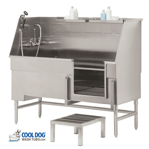 A stainless steel dog washing tub with a faucet, sprayer hose, shampoo bottles on a shelf, and a small step stool in front. The tub has a front opening and is elevated on metal legs. Logo: "Cool Dog Wash Tubs.