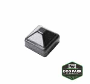 A glossy black Top Fence Post Cap with a sleek pyramid design. The bottom right corner displays a green and black "Dog Park Fencing" logo.