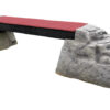 Ellie's Boulder Bridge Pro features a red walkway supported by two large gray faux-rocks and bumper pads, ideal for canine training or play in dog parks.