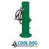 A green outdoor water fountain with a hose attached, designed for dogs. Below the fountain is a logo with a dog illustration and the text "COOL DOG WATER FOUNTAINS.COM.
