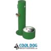 A green outdoor dog water fountain with a round bowl at the base, a drinking spout, and hose connection. The Cool Dog Water Fountains logo with a dog illustration appears below.