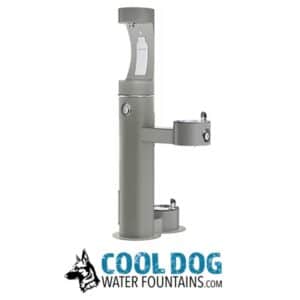 A gray outdoor water fountain with three spouts at different heights for adults, children, and dogs. Below is a logo with a dog illustration and the text "Cool Dog Water Fountains.com".
