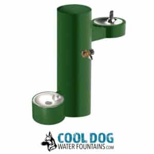 A green outdoor water fountain with two bowls at different heights and a faucet, designed for both people and dogs. The words "Cool Dog Water Fountains" and a dog logo appear below.