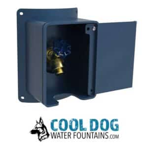 A blue outdoor water spigot in a wall-mounted box with an open door, showing a brass valve. Below is a logo with a dog illustration and the text "COOL DOG WATER FOUNTAINS.COM".