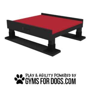 Rectangular black and red dog agility platform with a bone design on the side. Below it, text reads "Play & Agility Powered by GymsForDogs.com" with a paw print graphic.