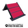 A red and black A-frame dog agility ramp with the text "Play & Agility Powered by GymsForDogs.com" and a paw print logo at the bottom.