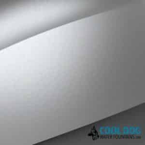 Close-up of the smooth, curved metallic surface of the Doggie Demand COOL DOG Fresh Flow Water Fountain Spout and Pet Hose (SLV), featuring its logo and a dog illustration in the bottom right corner.